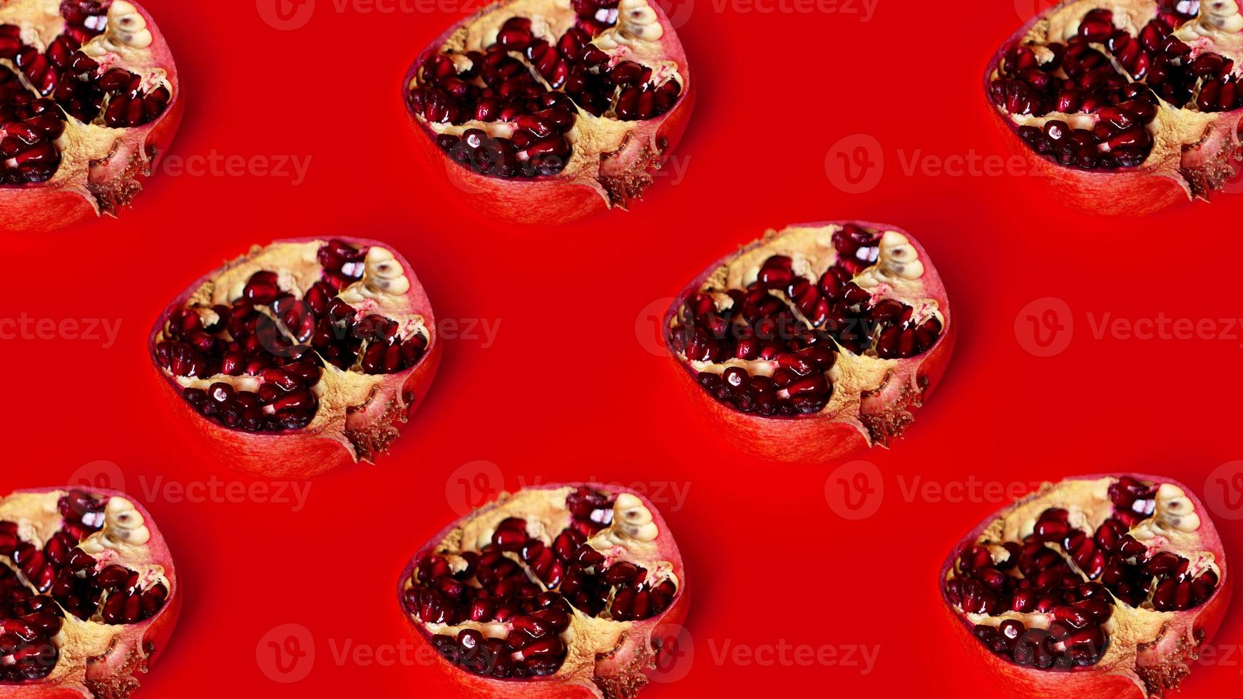 Pattern of red pomegranates in rows on red background photo