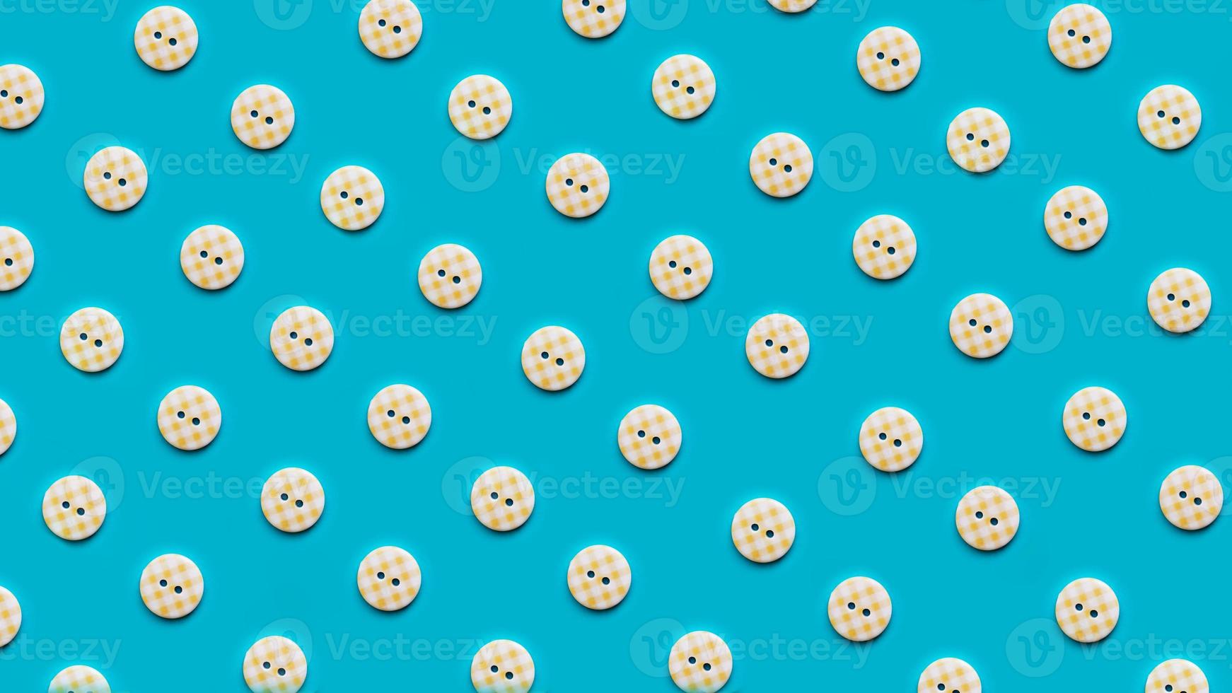 Top view of buttons arranged on blue background photo