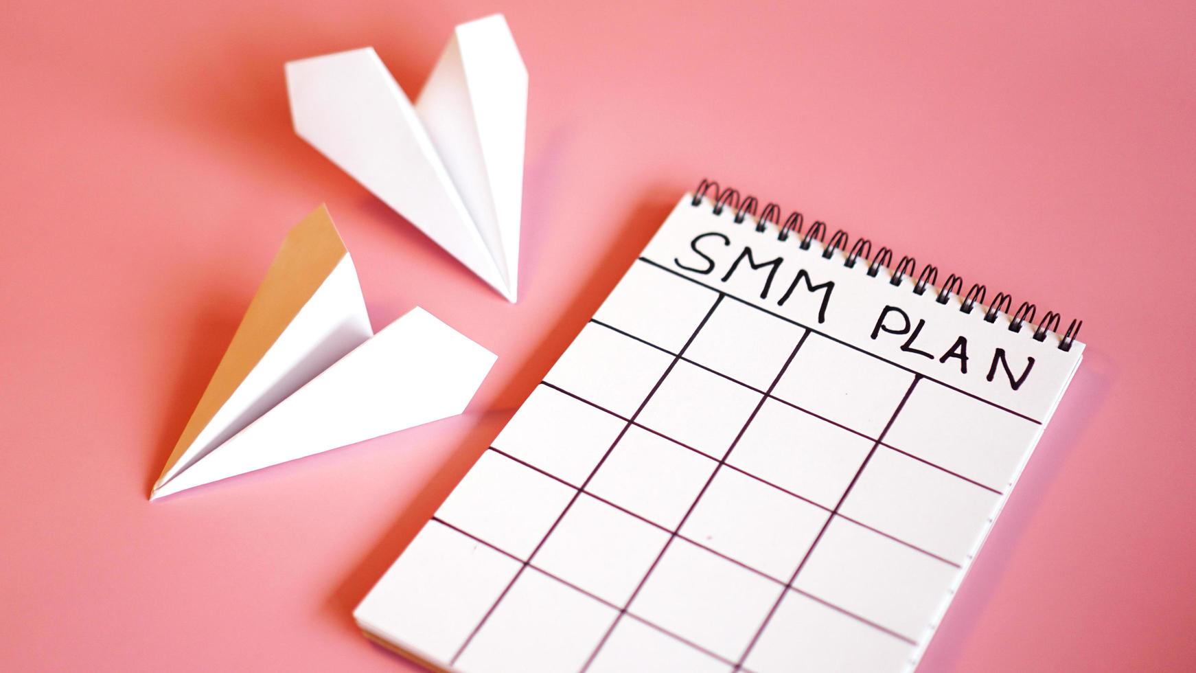 Social media marketing concept - SMM plan on a pink background photo