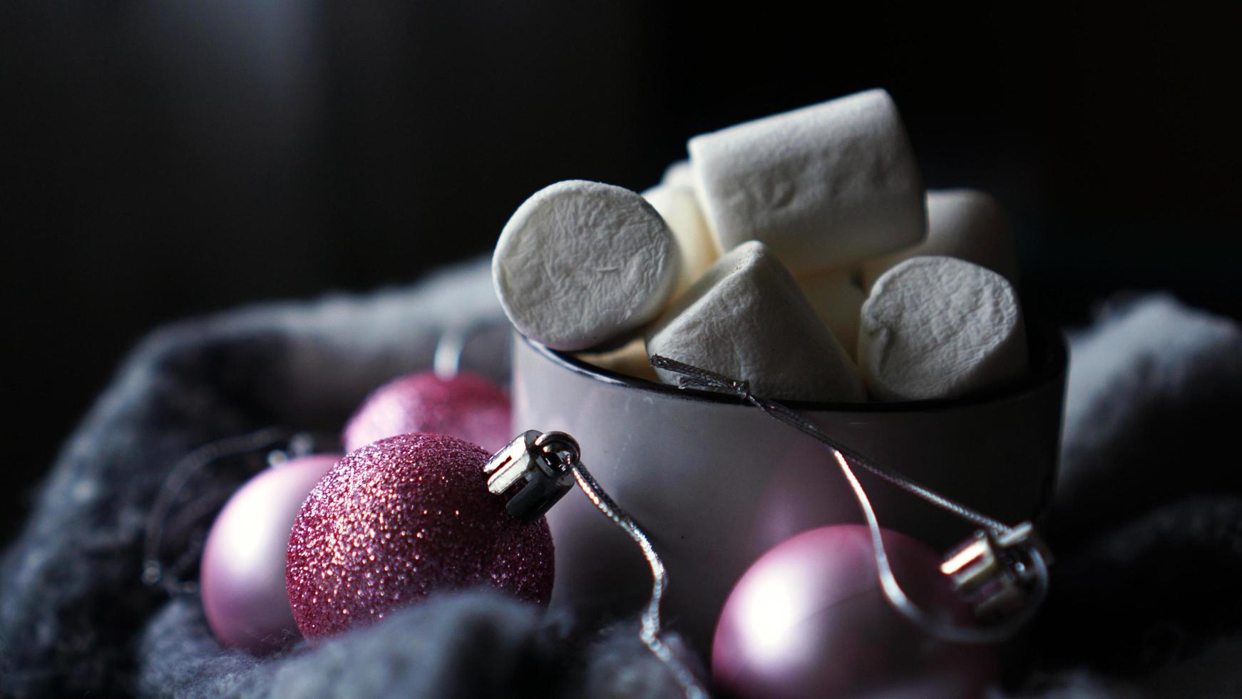 Mug of hot chocolate with marshmallow on a dark background photo