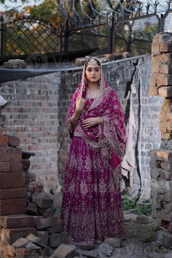 Girl standing in broken house photo