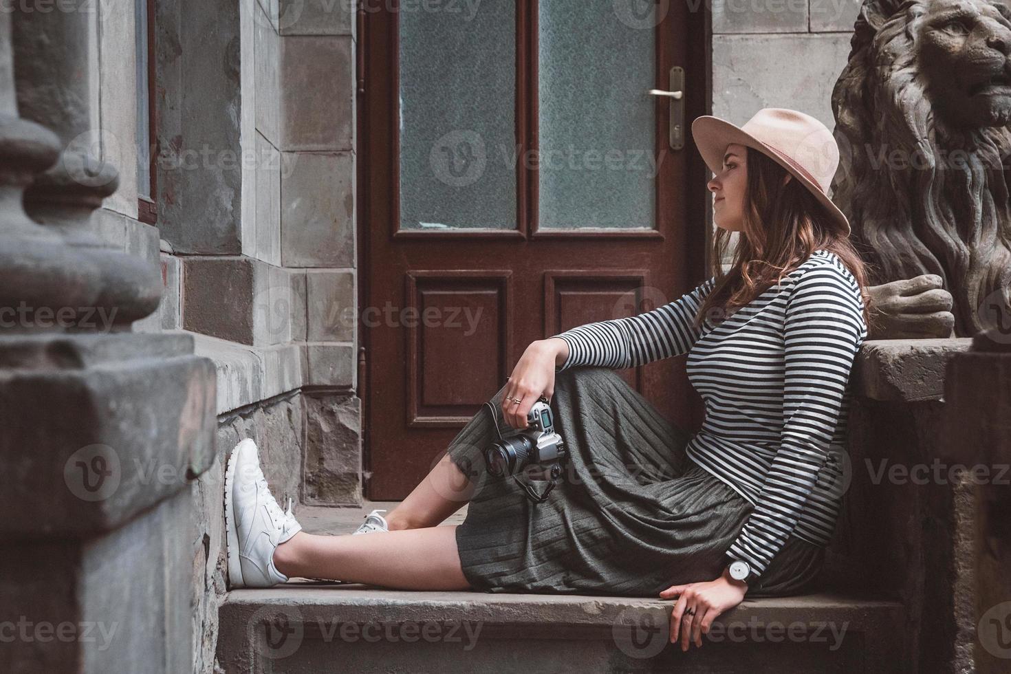 beautiful woman in hat holds old fashioned camera photo