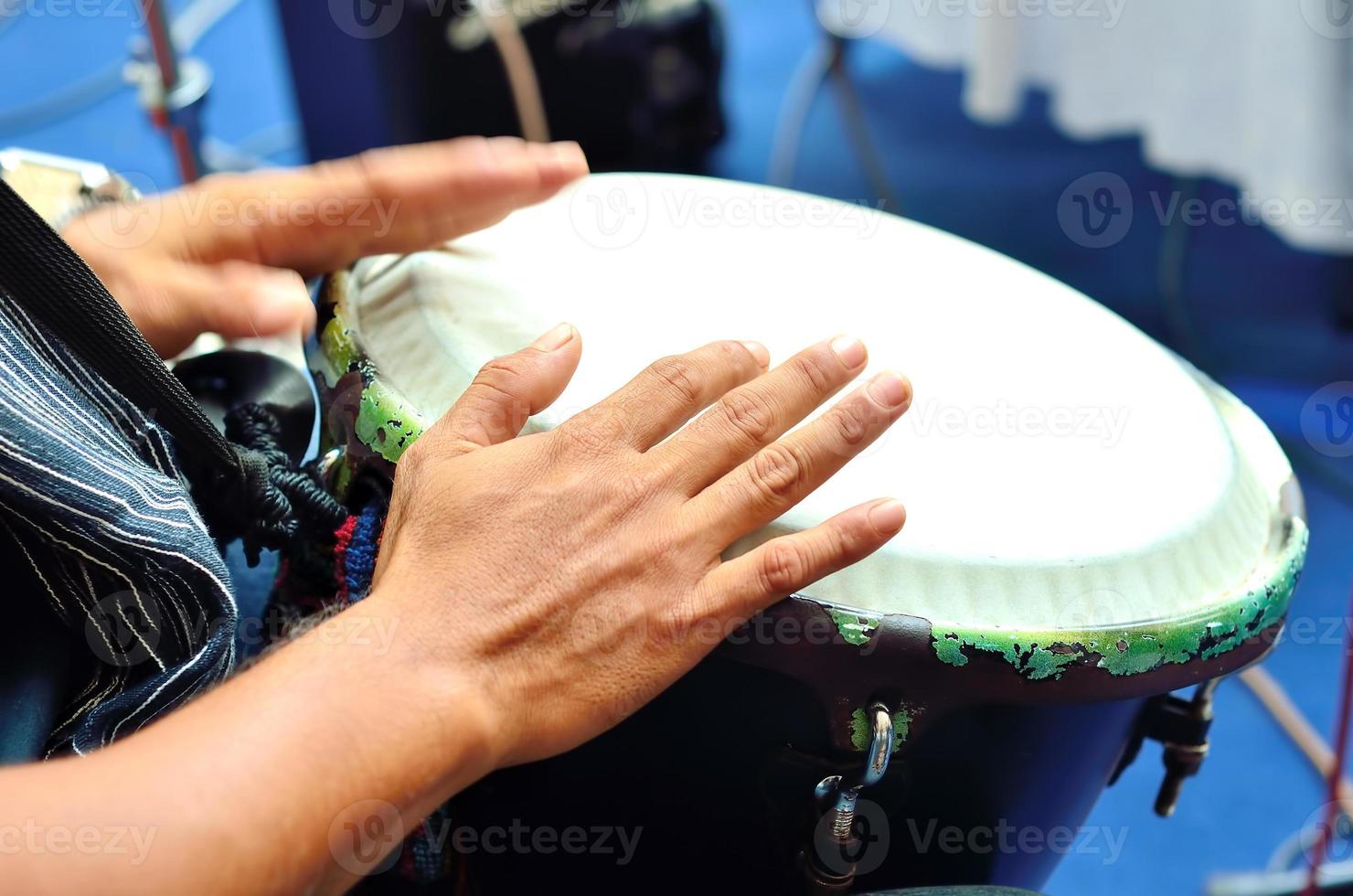 Playing the drum. Focus on the hand and other hand in motion photo