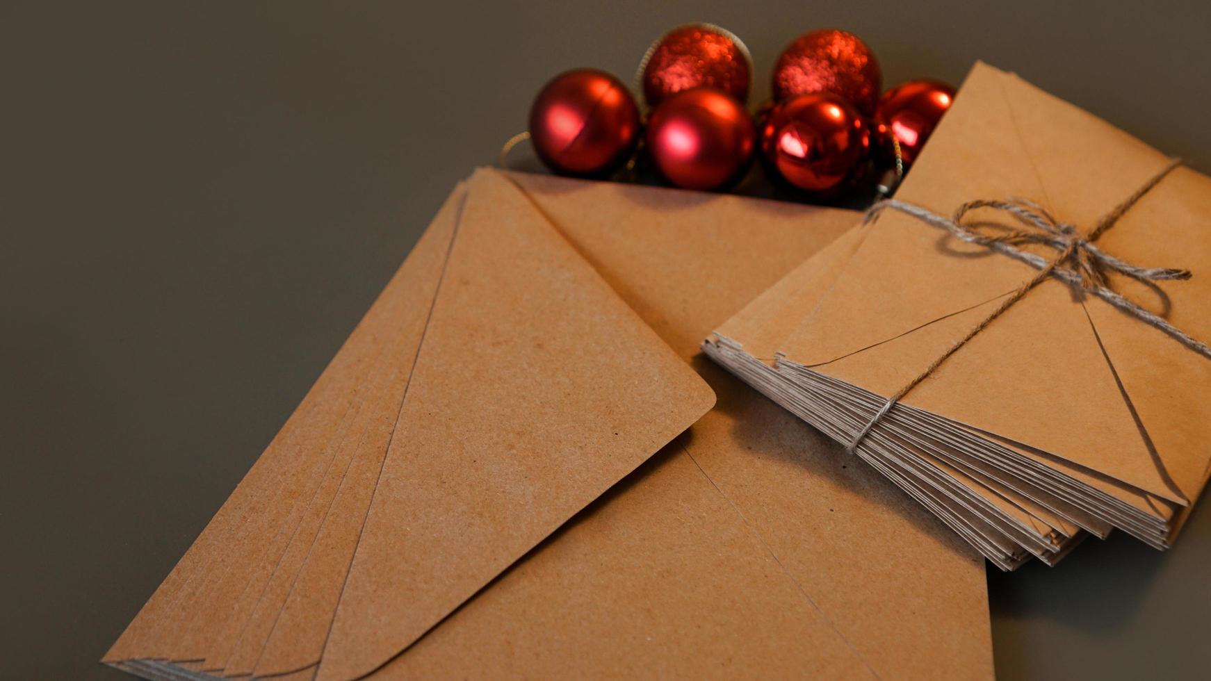 Christmas composition. Craft envelopes and red balls photo