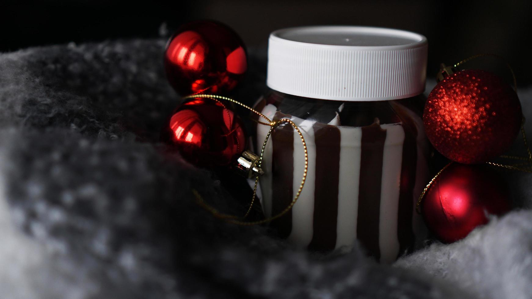 Sweet chocolate cream in the jar against Christmas background photo