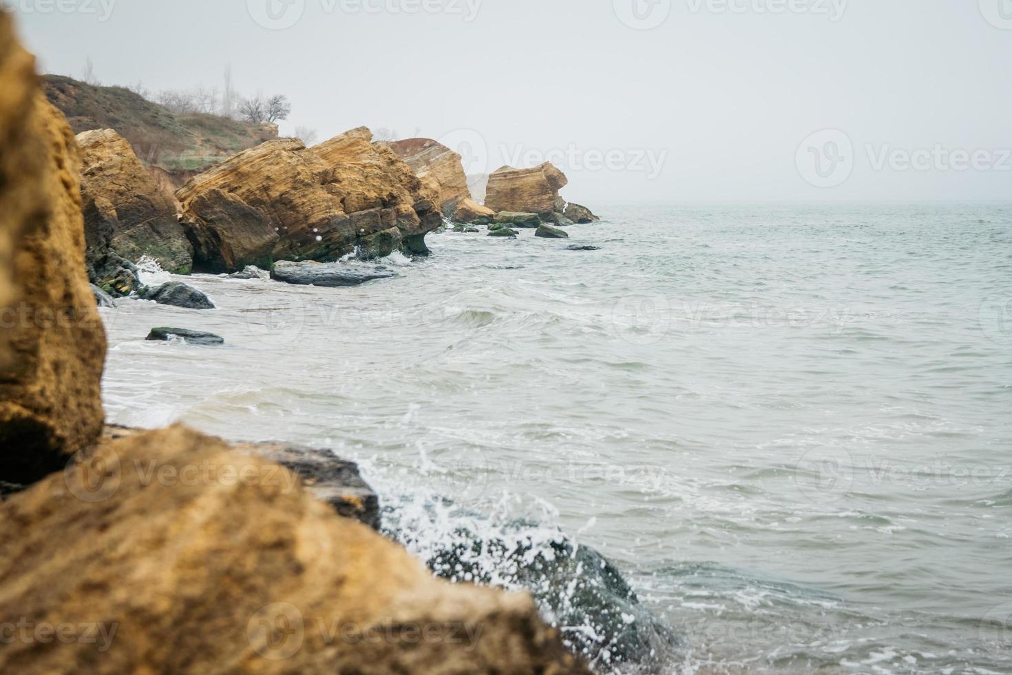 Yellow and red sandstone cliffs are located on the seafront photo