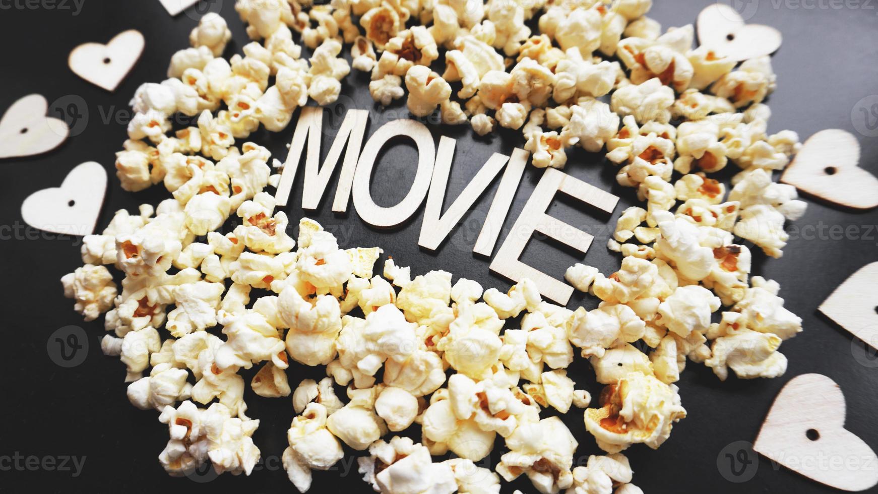 Popcorn on black background. Watching a movie with popcorn photo