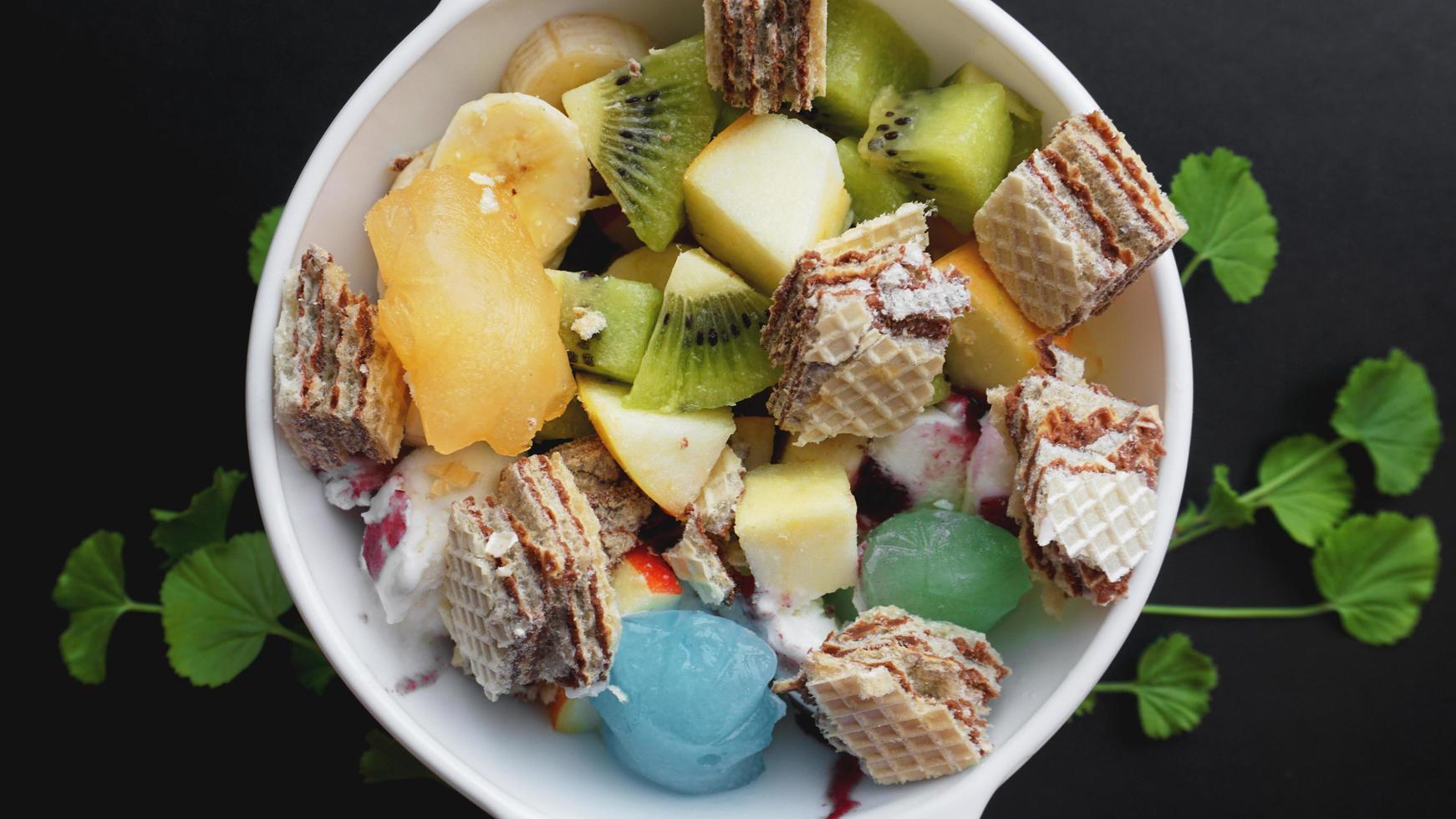 Close up desert with fresh fruit and ice cream photo
