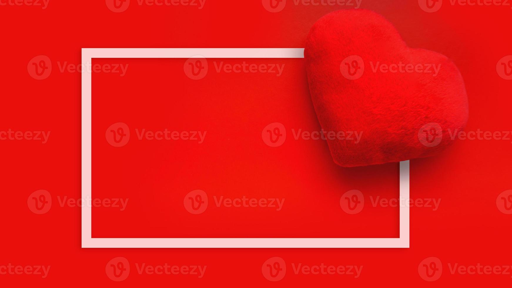 Valentines day love background with soft toy heart on red background photo