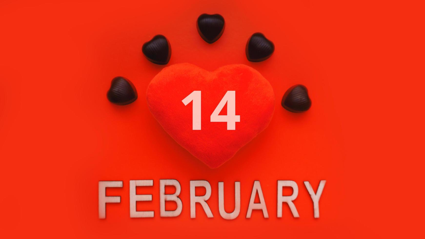 Valentines day background with soft toy heart and chocolates photo