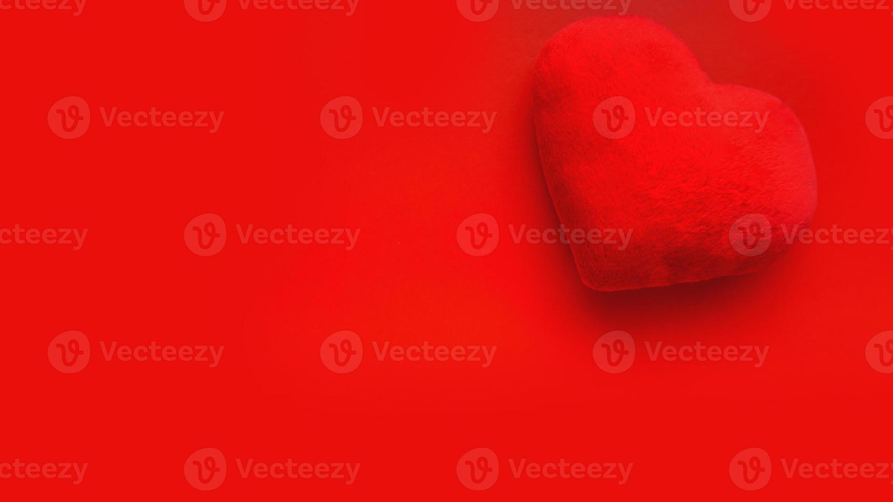 Valentines day love background with soft toy heart on red background photo