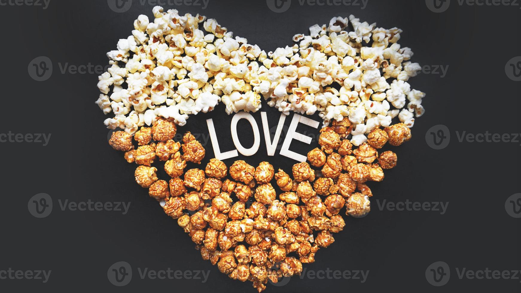 Love Cinema concept of popcorn arranged in a heart shape photo