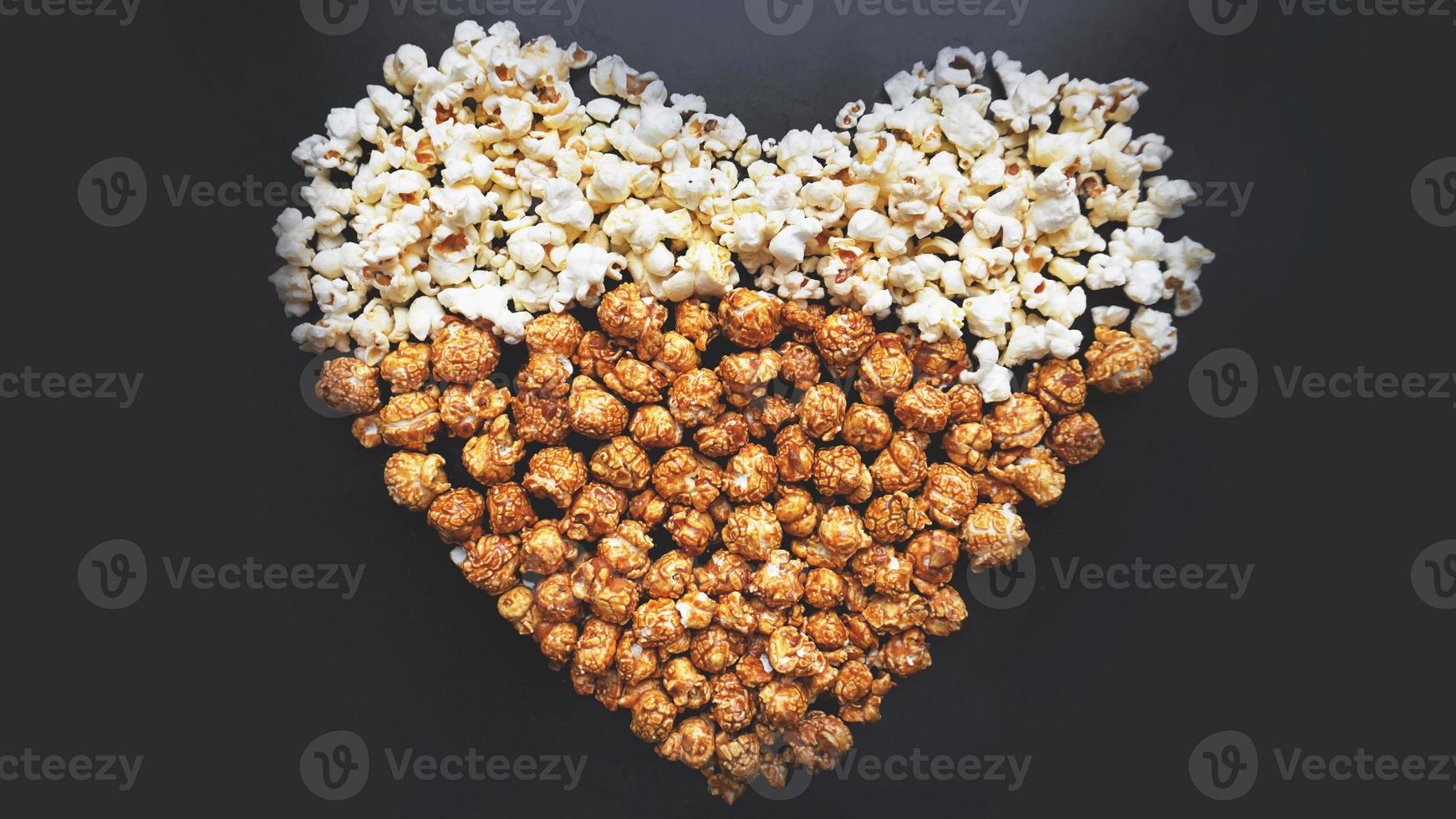 Love Cinema concept of popcorn arranged in a heart shape. photo