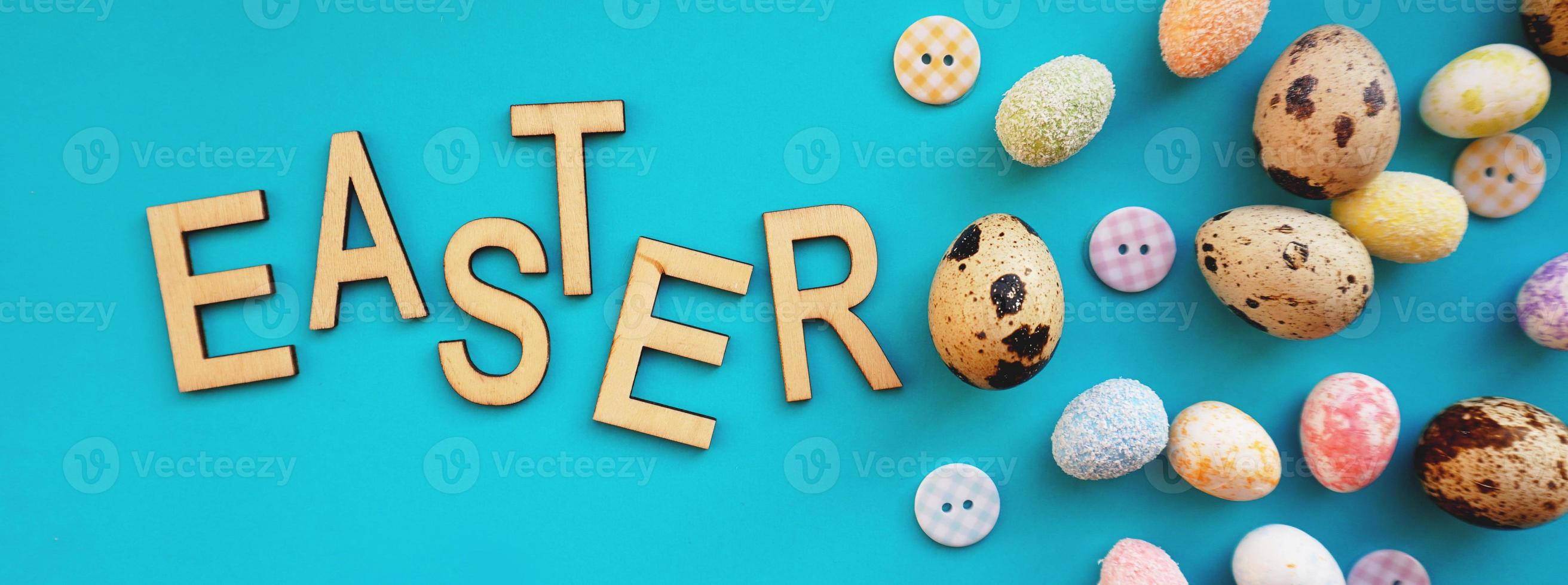 Quail Easter eggs on blue background. Flat lay, top view photo