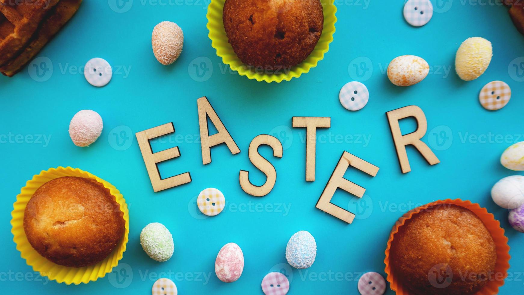 Decor Easter eggs on blue background. Flat lay, top view photo