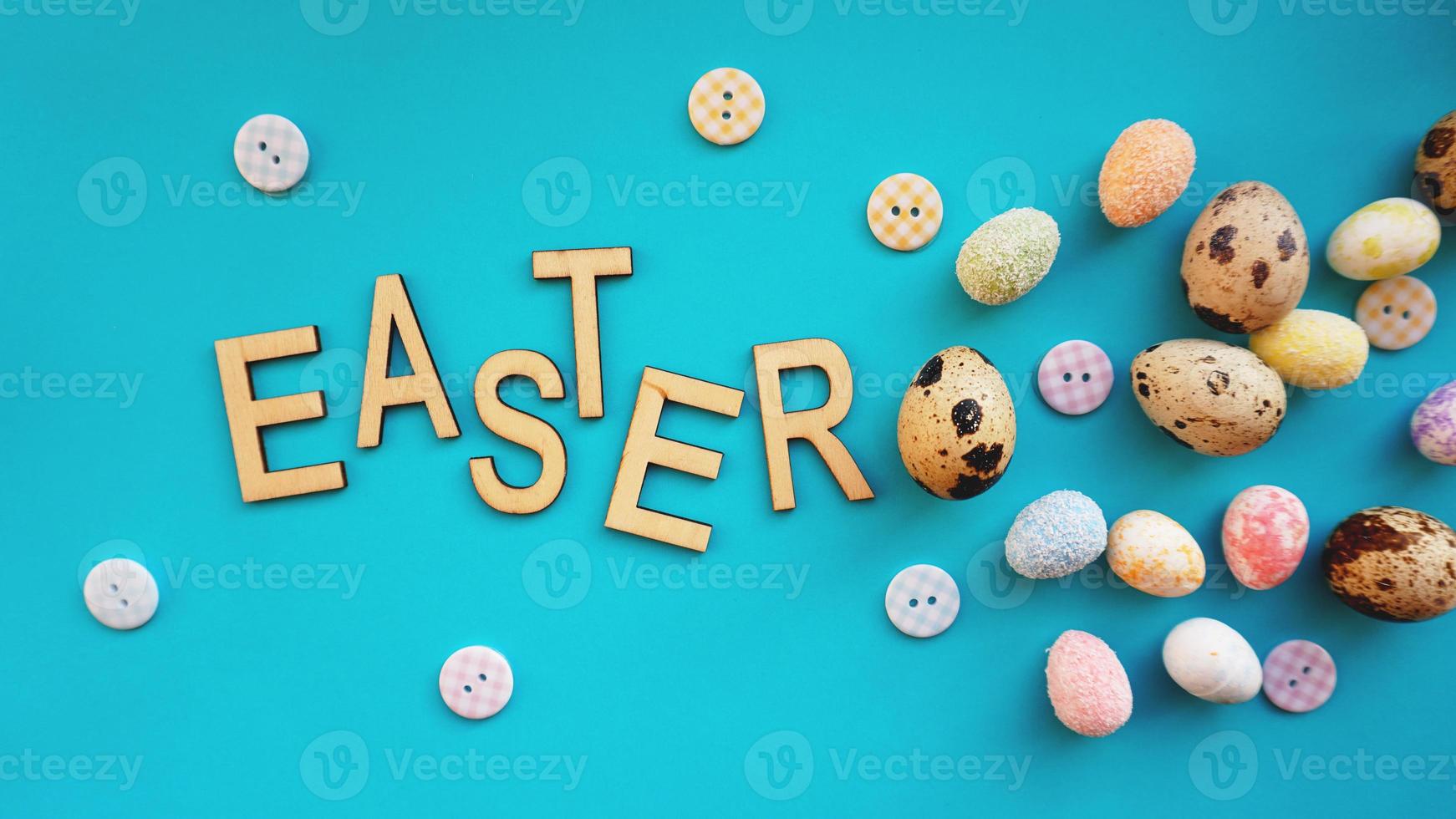 Quail Easter eggs on blue background. Flat lay, top view photo