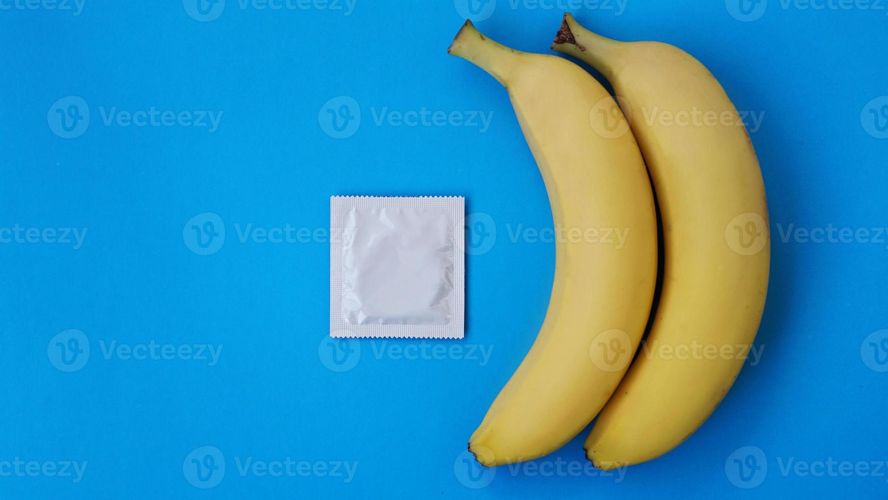 Condoms and two bananas together, concept of contraceptives photo