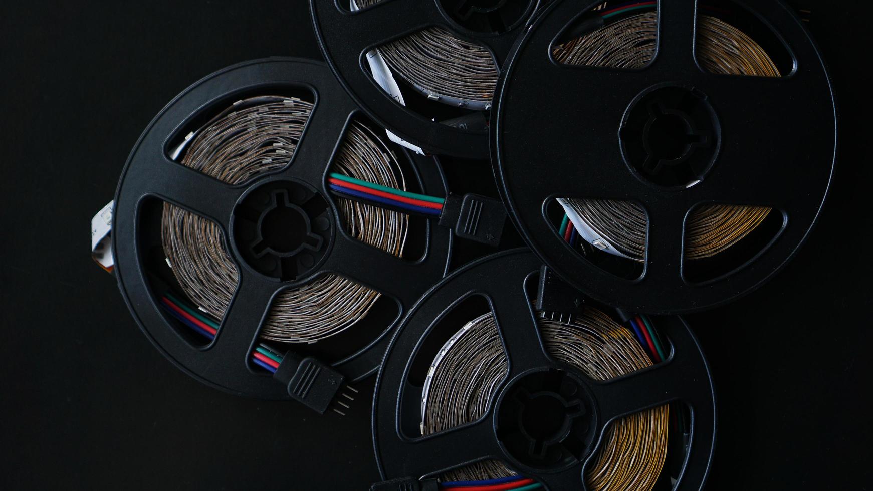 Coils of rgb led strip on a black table. Led strip photo