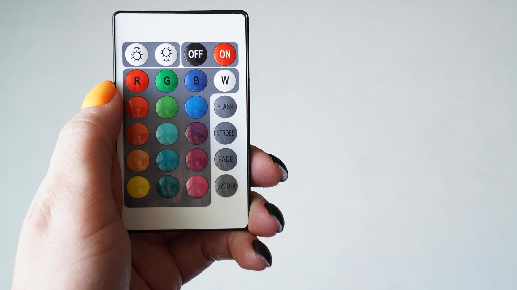 Control remoto para cambiar colores en mano aislado en blanco foto