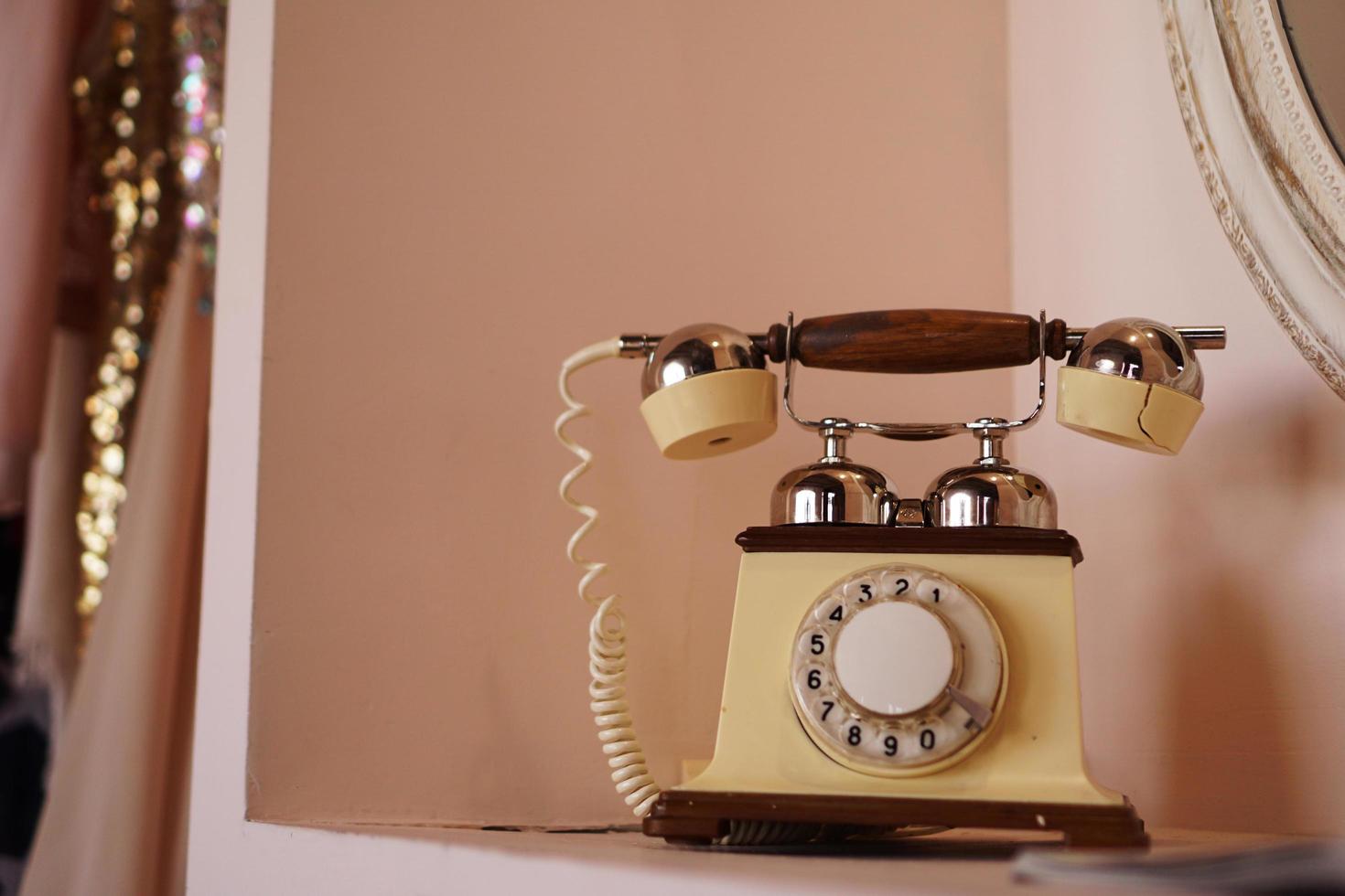 Old retro phone on the shelf photo