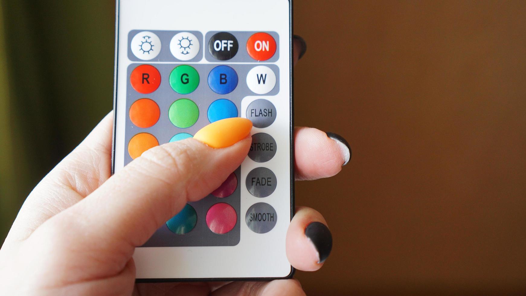 Remote control for change colors in hand photo