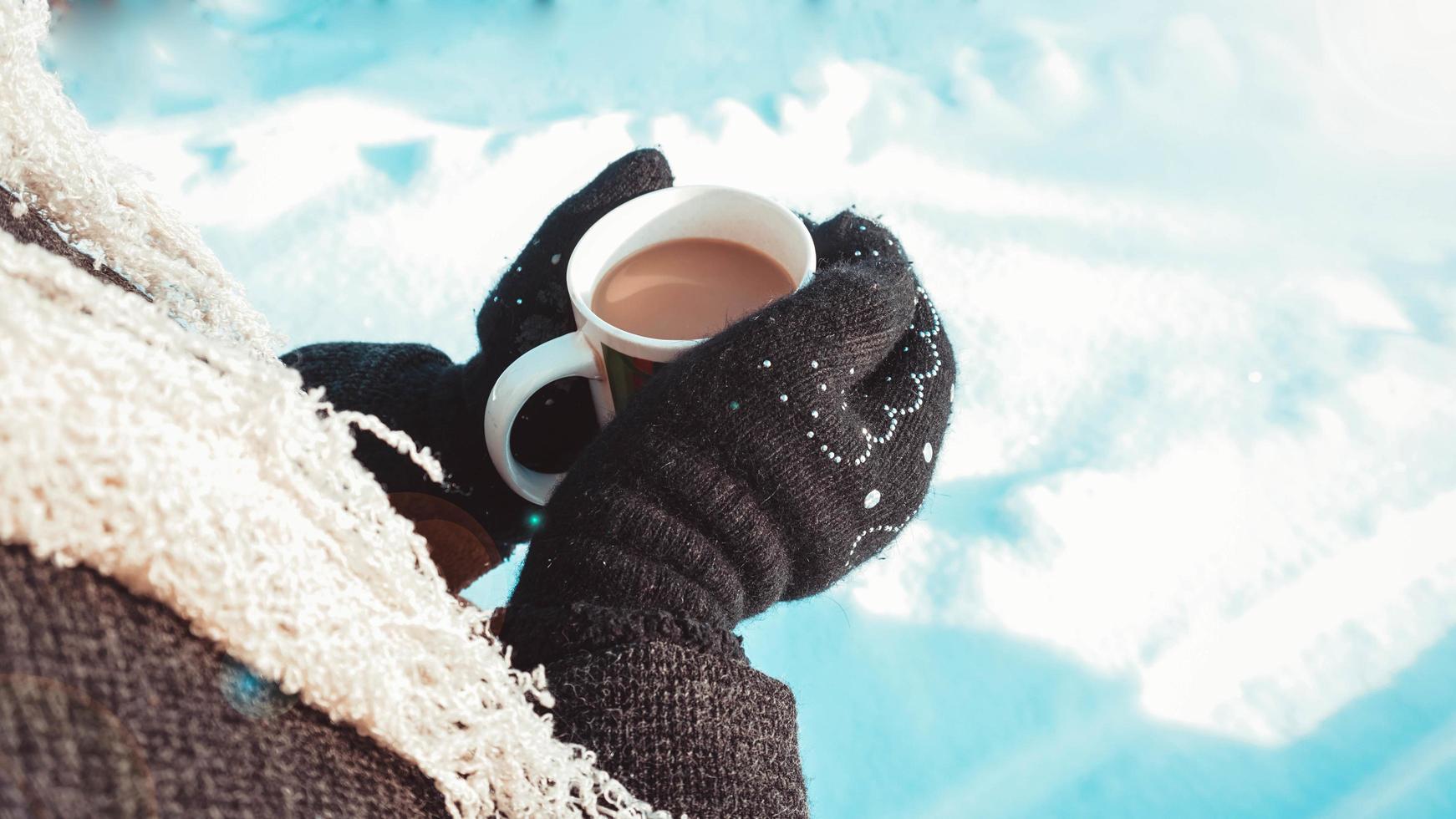 Warm cup of hot coffee warming in the hands of a girl photo