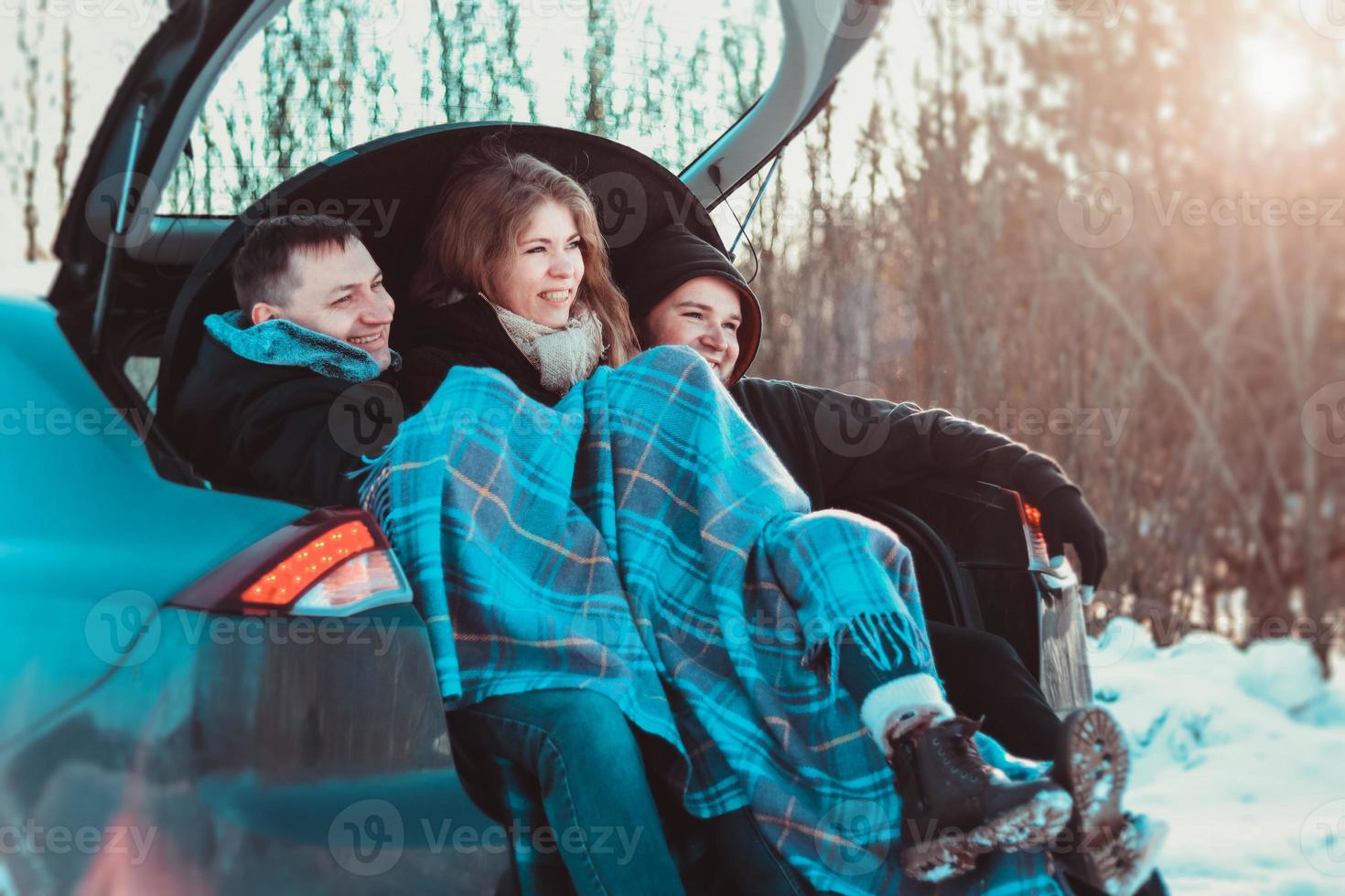 Enjoying road trip with best friends. Group of young cheerful people photo