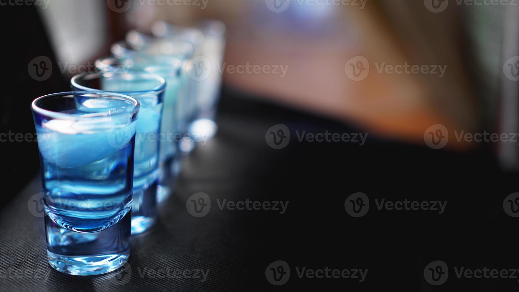 Glasses of vodka with ice. In bar photo
