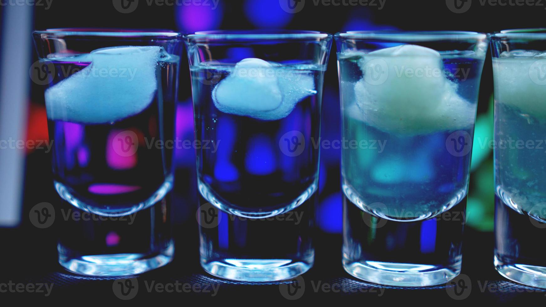 Glasses of vodka with ice. In bar photo