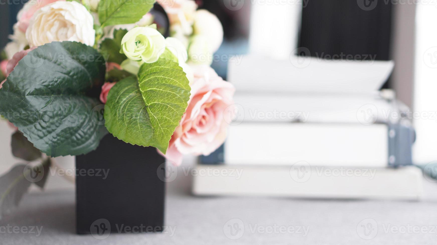 Female workspace with flowers bouquet on white photo