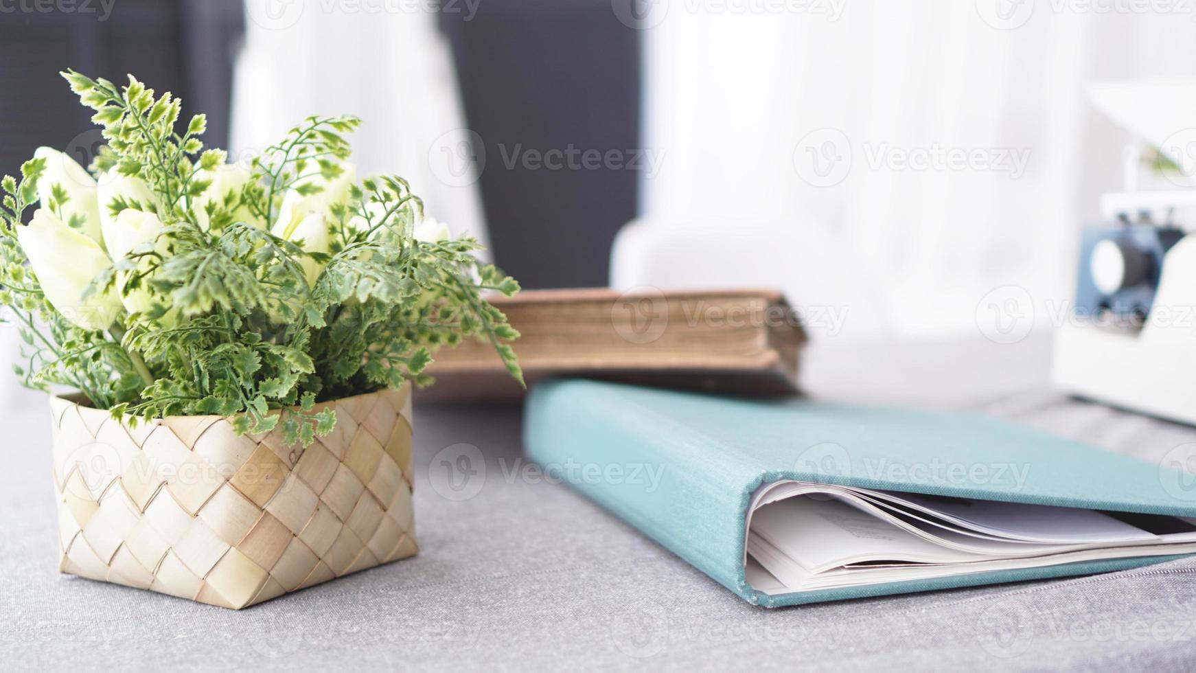 Female workspace with flowers bouquet on white photo