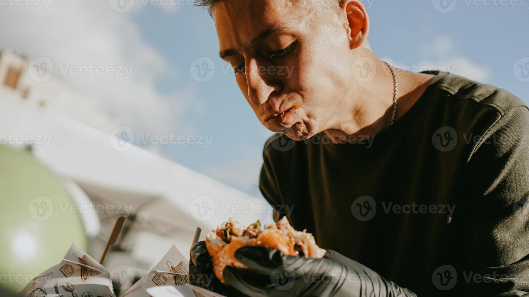 Man enjoing outdoor street food festival, Beer and Burger event photo