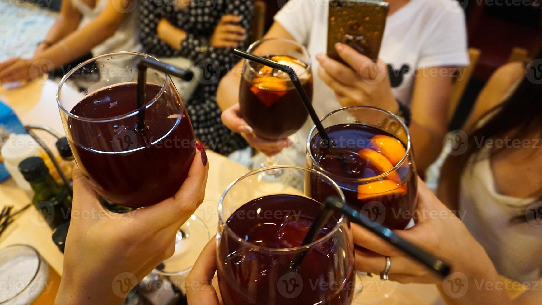 Cheerful company in the bar holds glasses photo