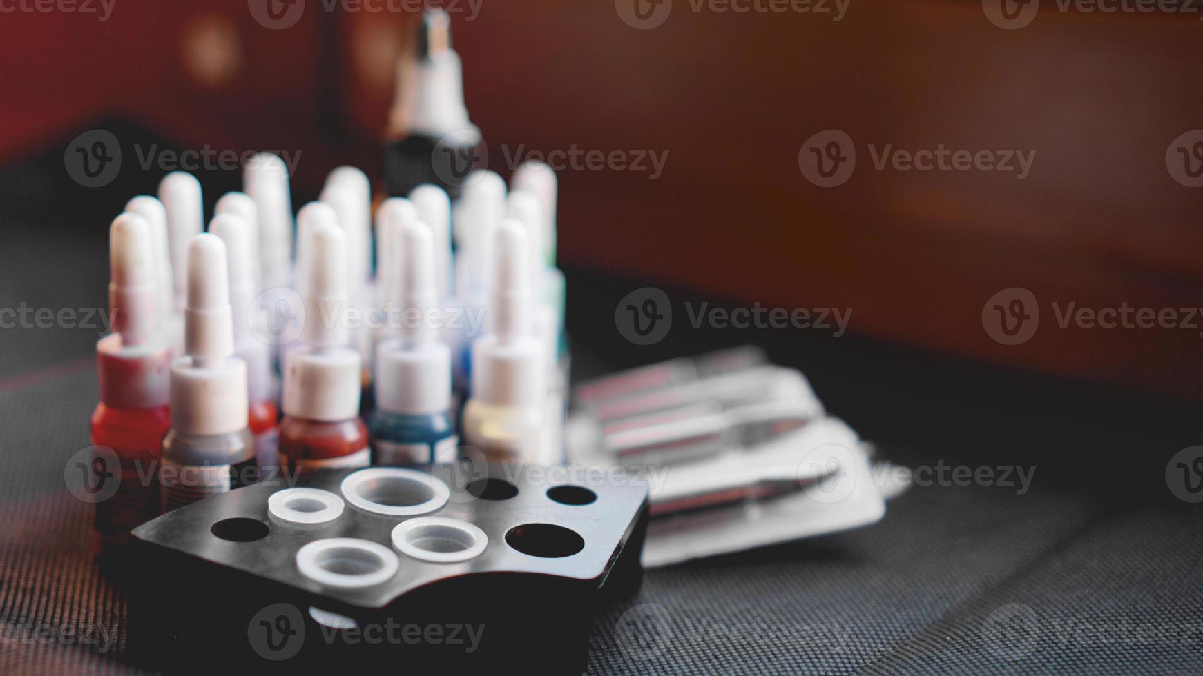 Many professional bottles with colored ink for tattoos photo