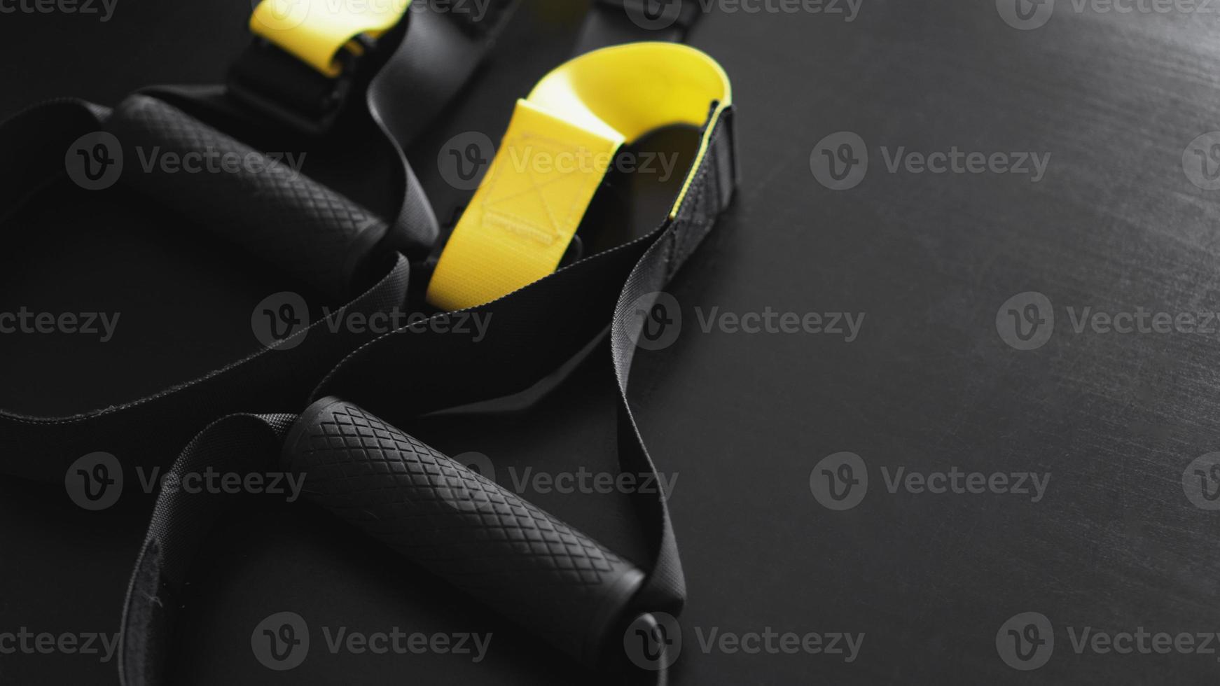 Training strap equipment on black background. Sport accessories photo