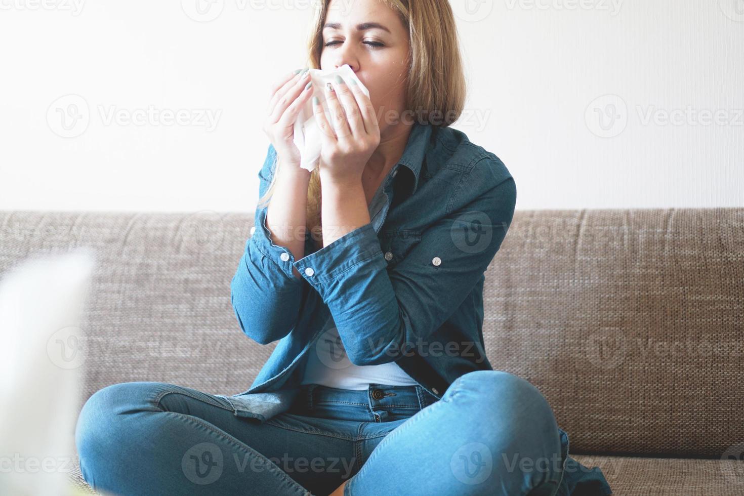 Portrait of unhealthy cute blonde female with napkin photo