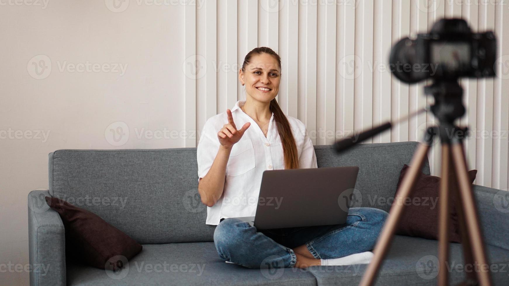 Smiling female blogger records a new video photo