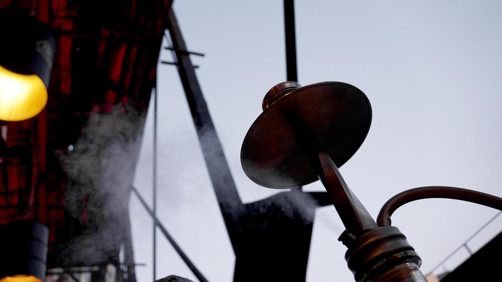 Close-up of a hookah bowl with charcoal. Hookah bar outside. photo