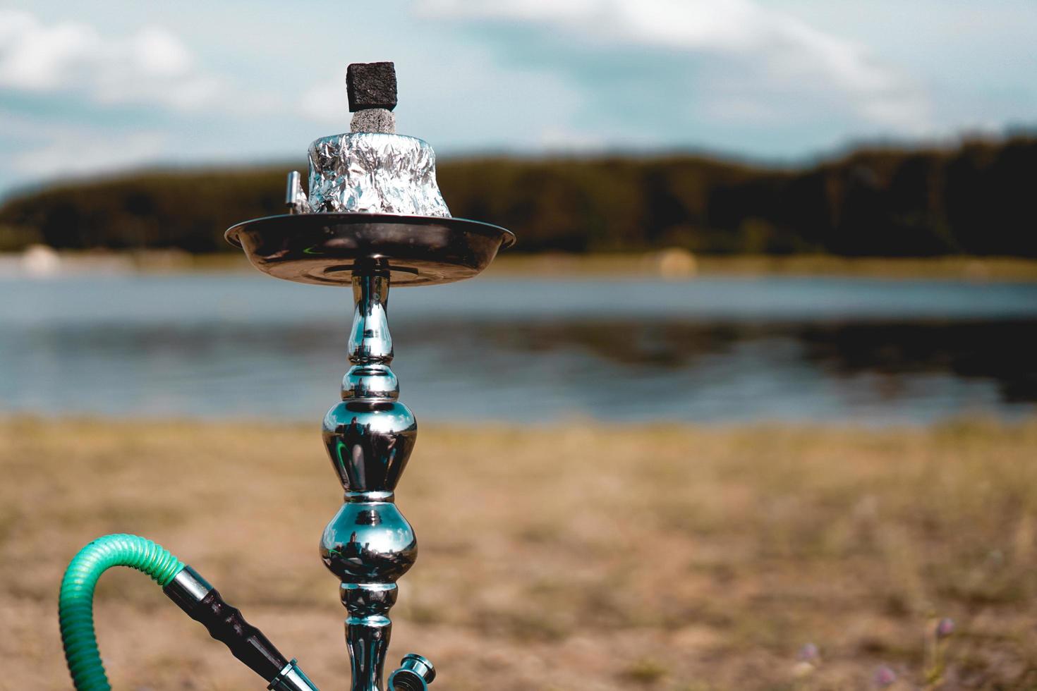 Hookah bowl stands in nature by the river close up photo