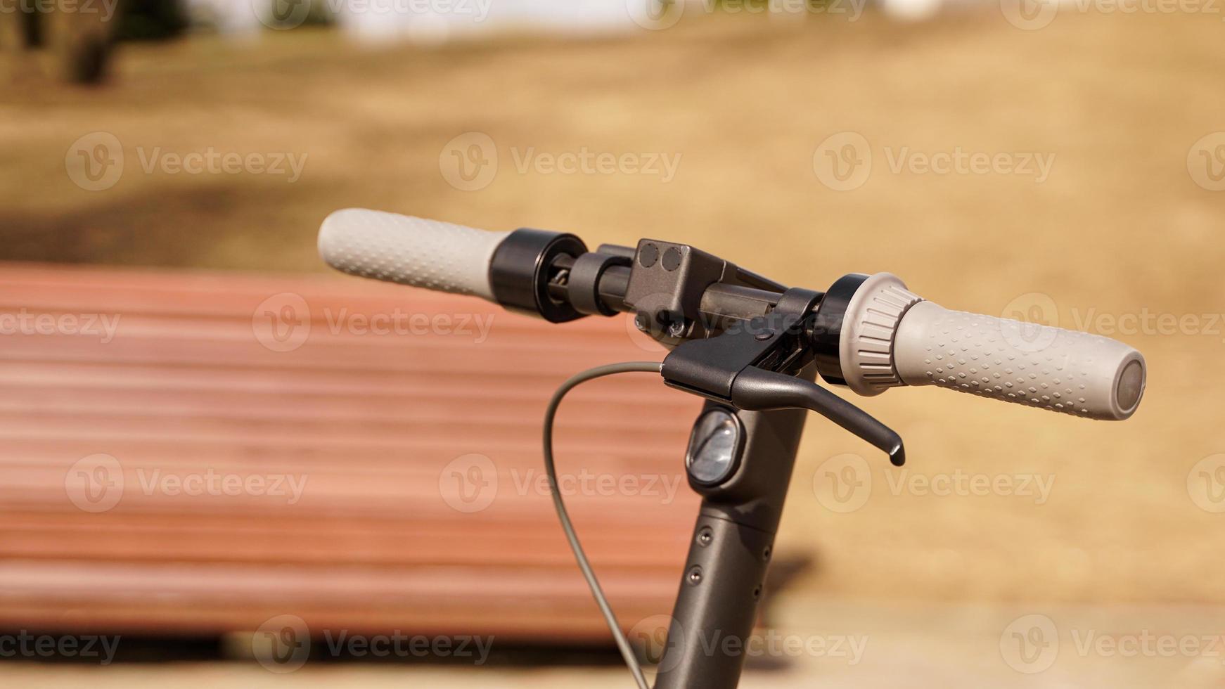 Close-up of the steering wheel of an electric scooter outside photo