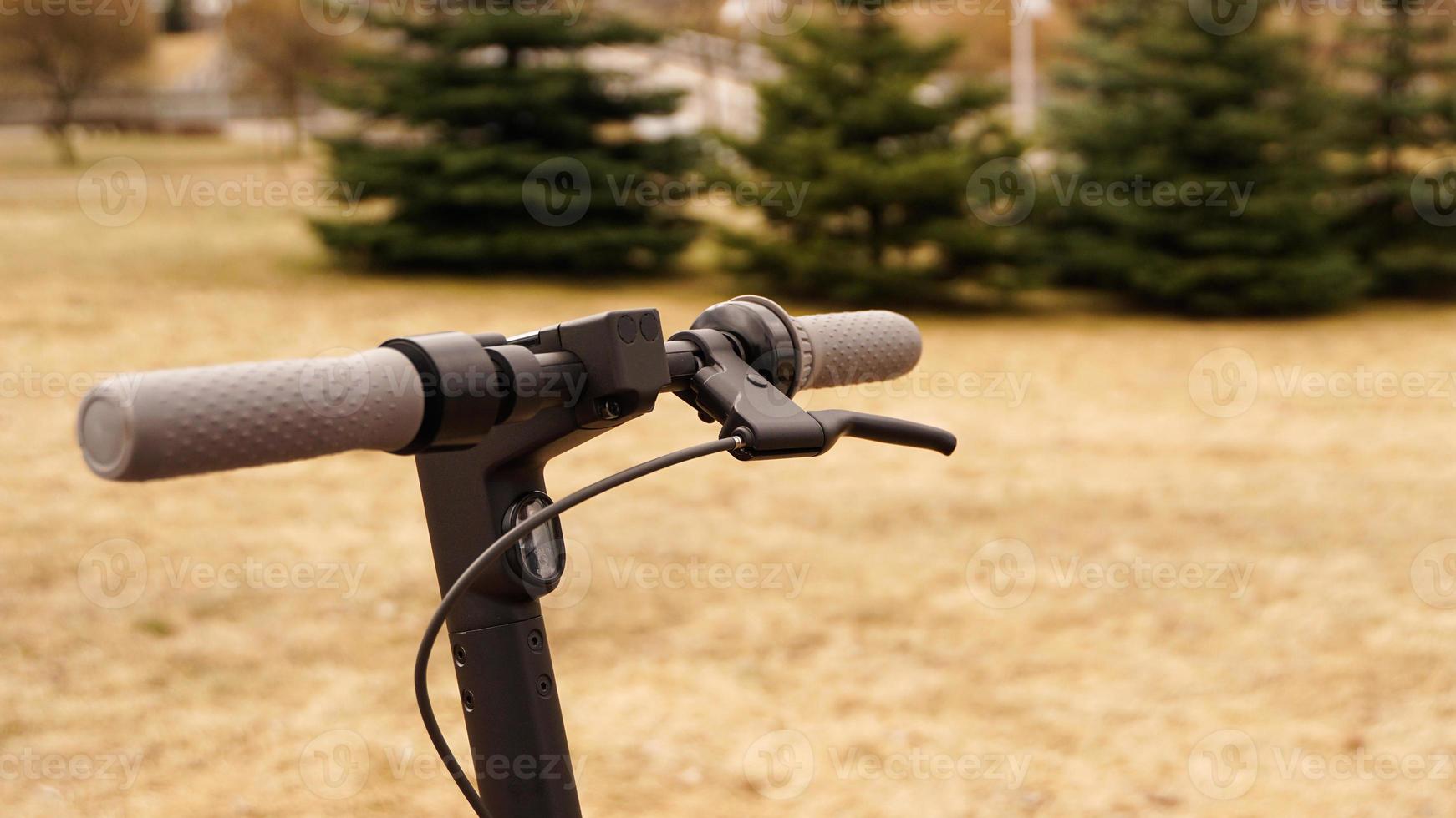 Close-up of the steering wheel of an electric scooter outside photo