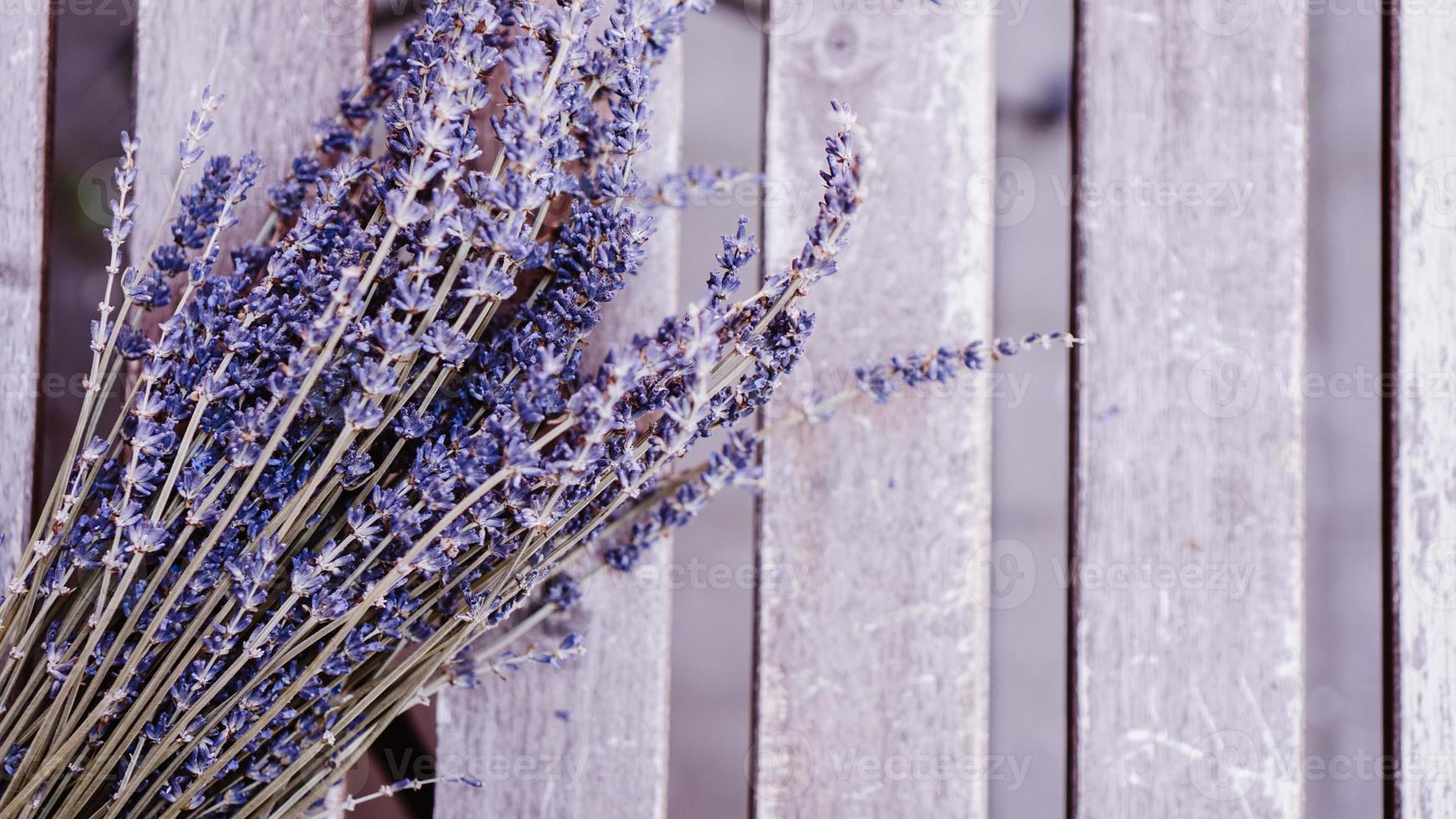 Dried lavender bunches on wooden table photo