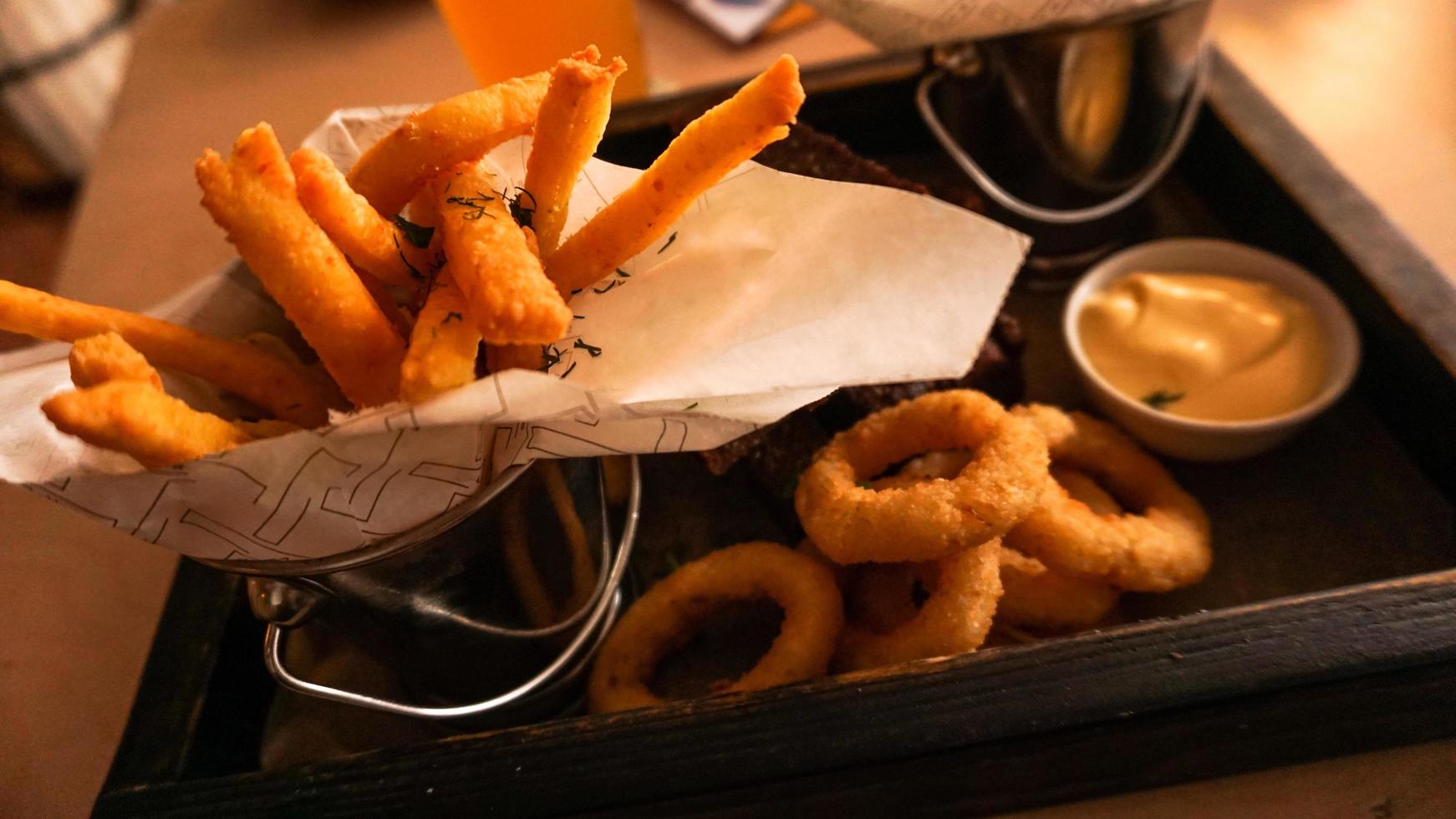 Beer set of snacks on a wooden tray. Snack for friends in a brasserie photo