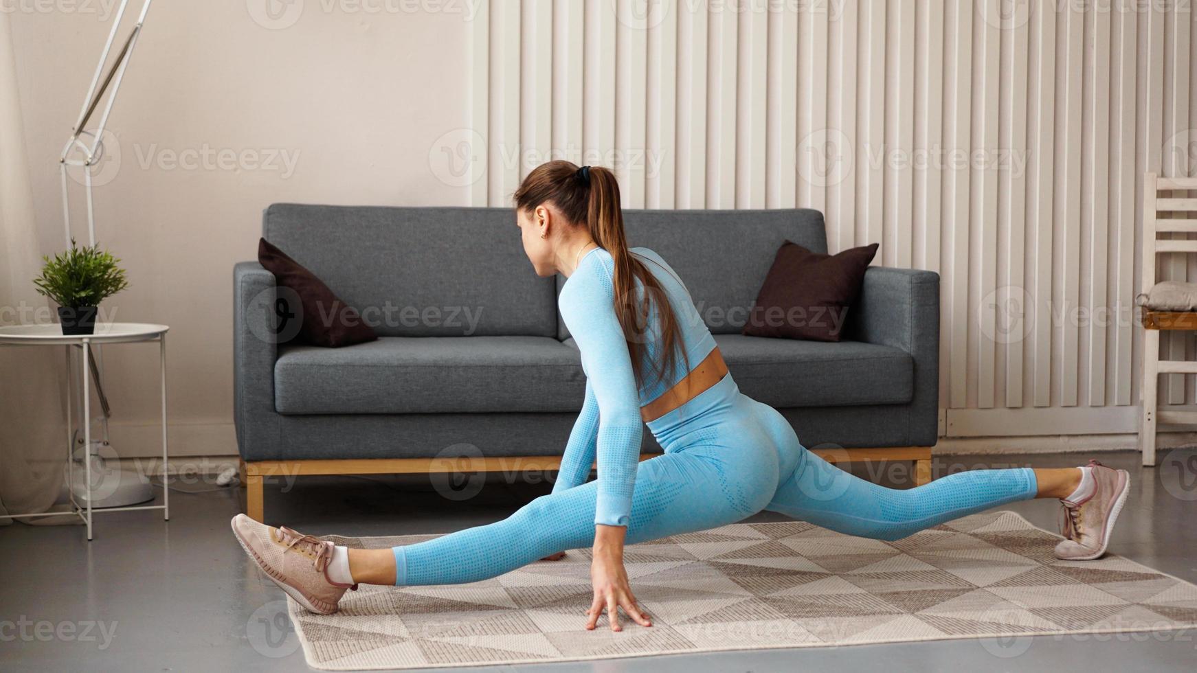 A woman in a blue tracksuit sits on a twine photo