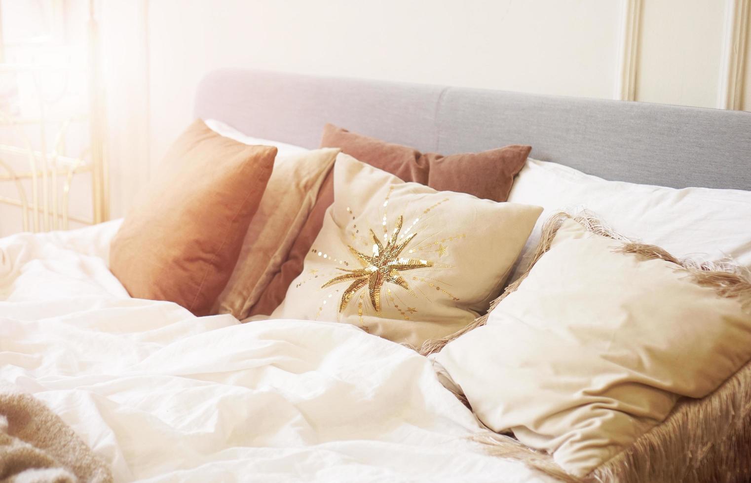 Closeup pillow on bed in warm bedroom modern interior photo