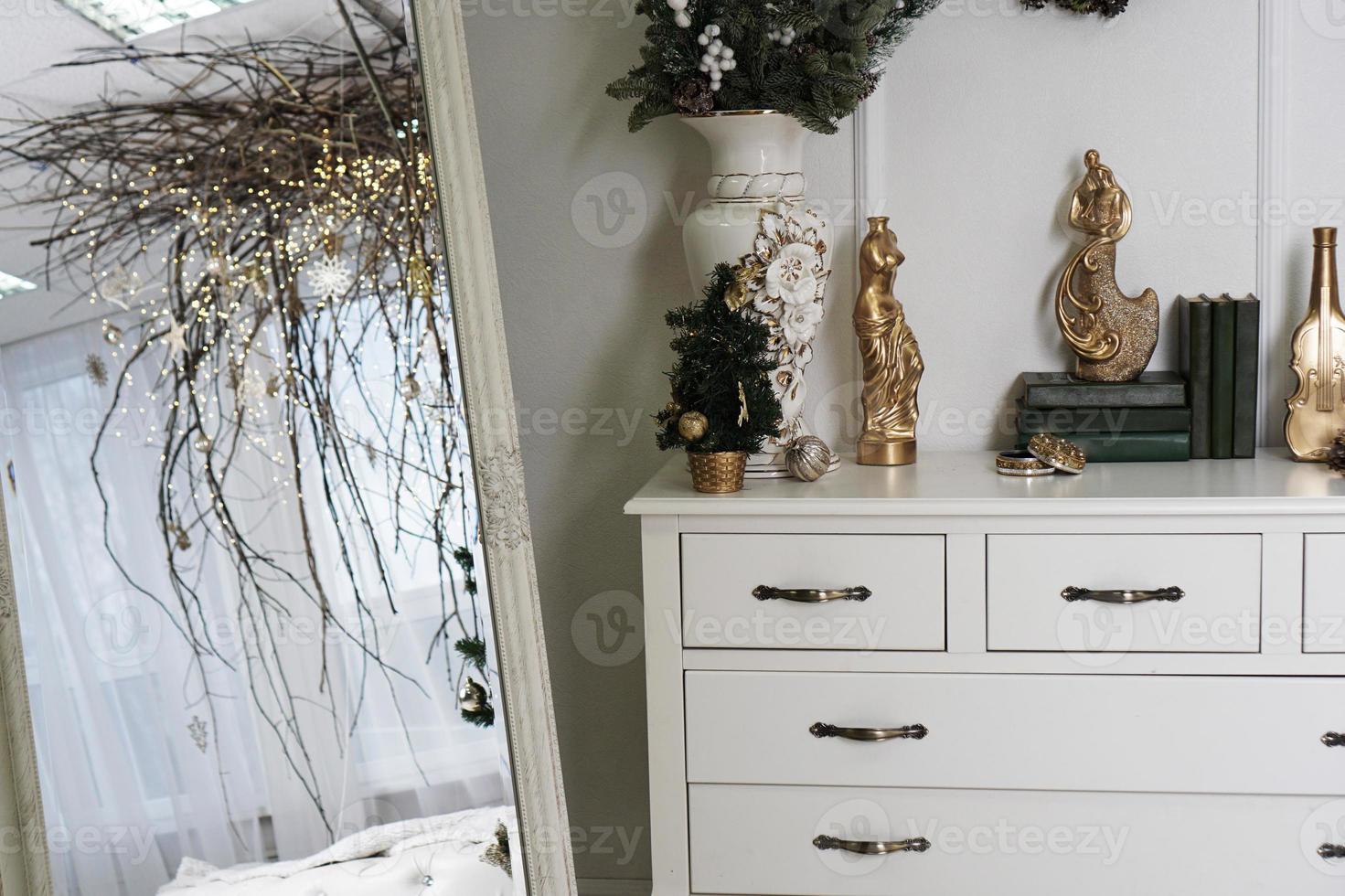 Bright white room with canopy of branches - christmas decoration photo