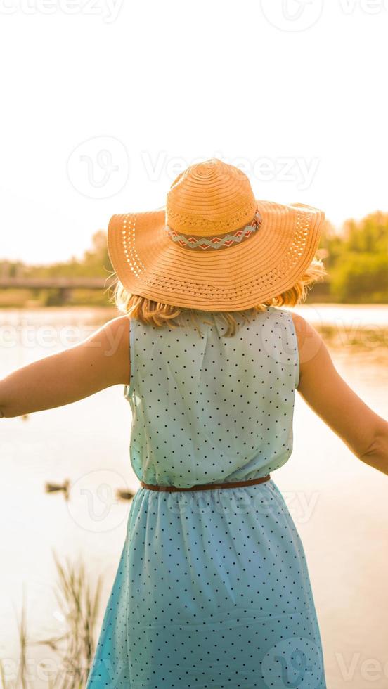 Spring Girl enjoying nature. Beautiful Young Woman Outdoors photo