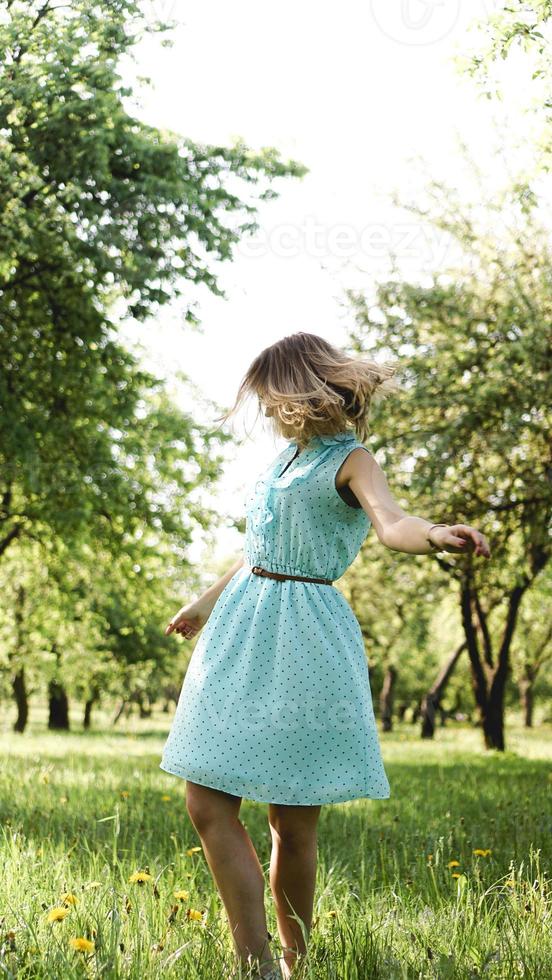 Young woman in sunny garden. Outdoor summer day. Freedom concept photo