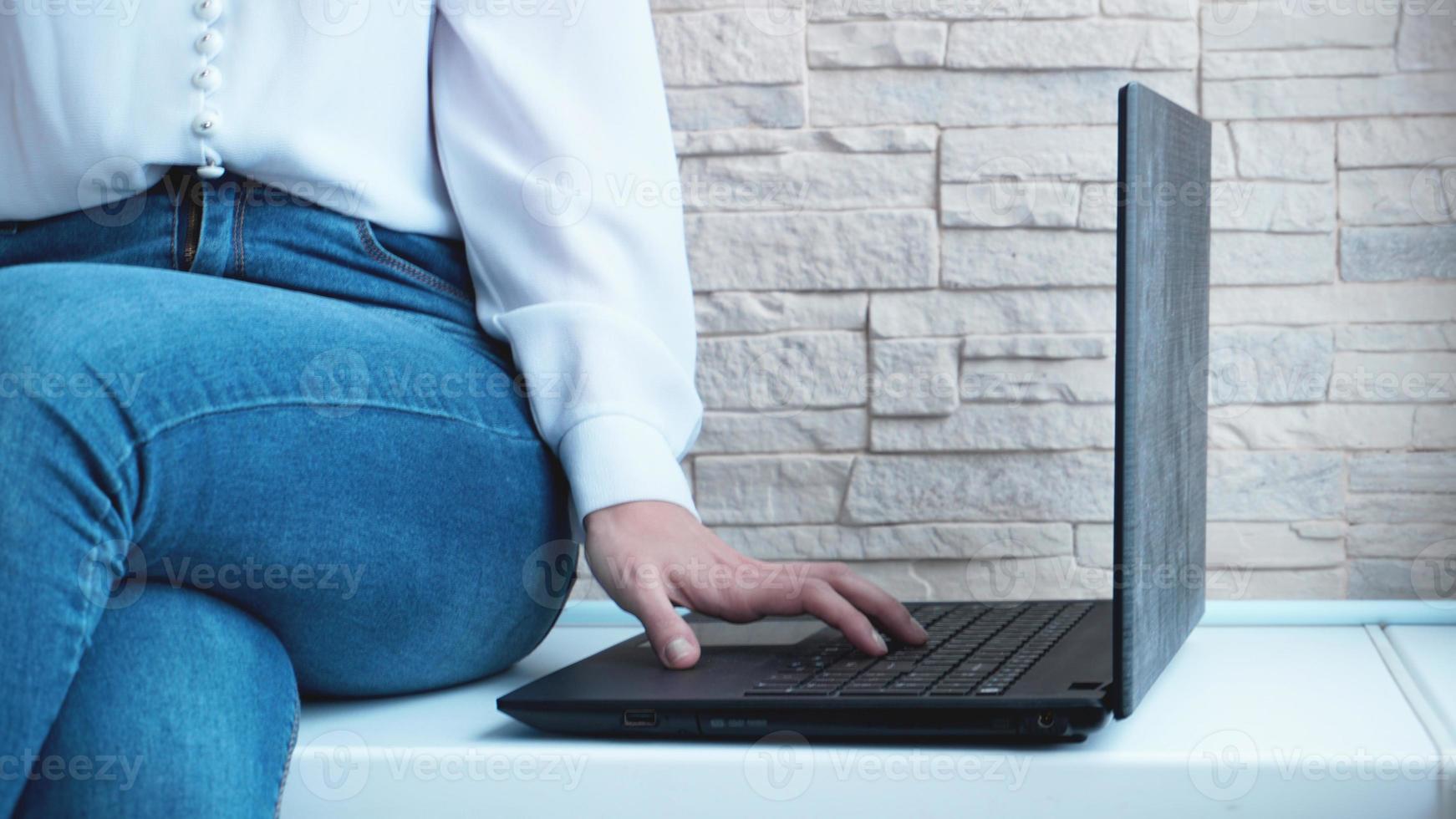 Woman working at home office hand on keyboard close up photo