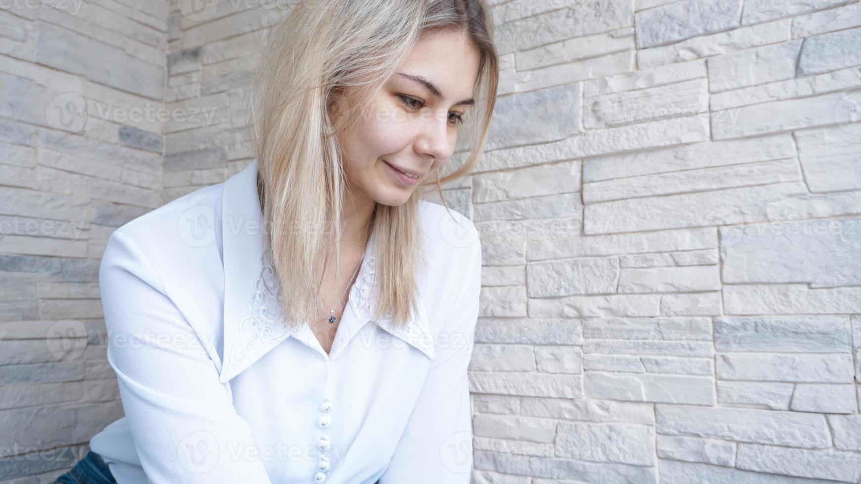 Side view. Young business woman looking down photo